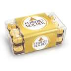 Ferrero Rocher chocolate with golden wrapping and hazelnut filling, displayed in a festive arrangement.