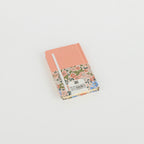 A6 floral notebook by 2BE featuring a vibrant flower pattern and a sturdy cover, ideal for journaling or notes.