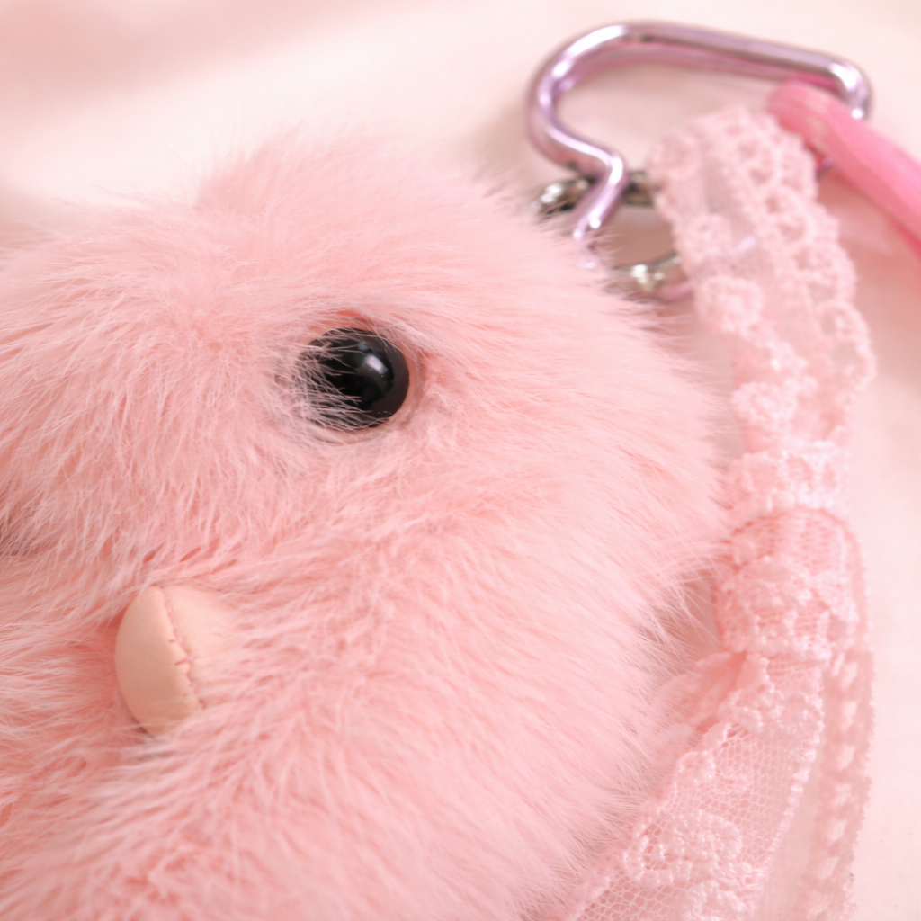 Givana fluffy bunny keychain in pink and white with soft, plush texture, featuring adorable bunny ears and a metal keyring attachment.