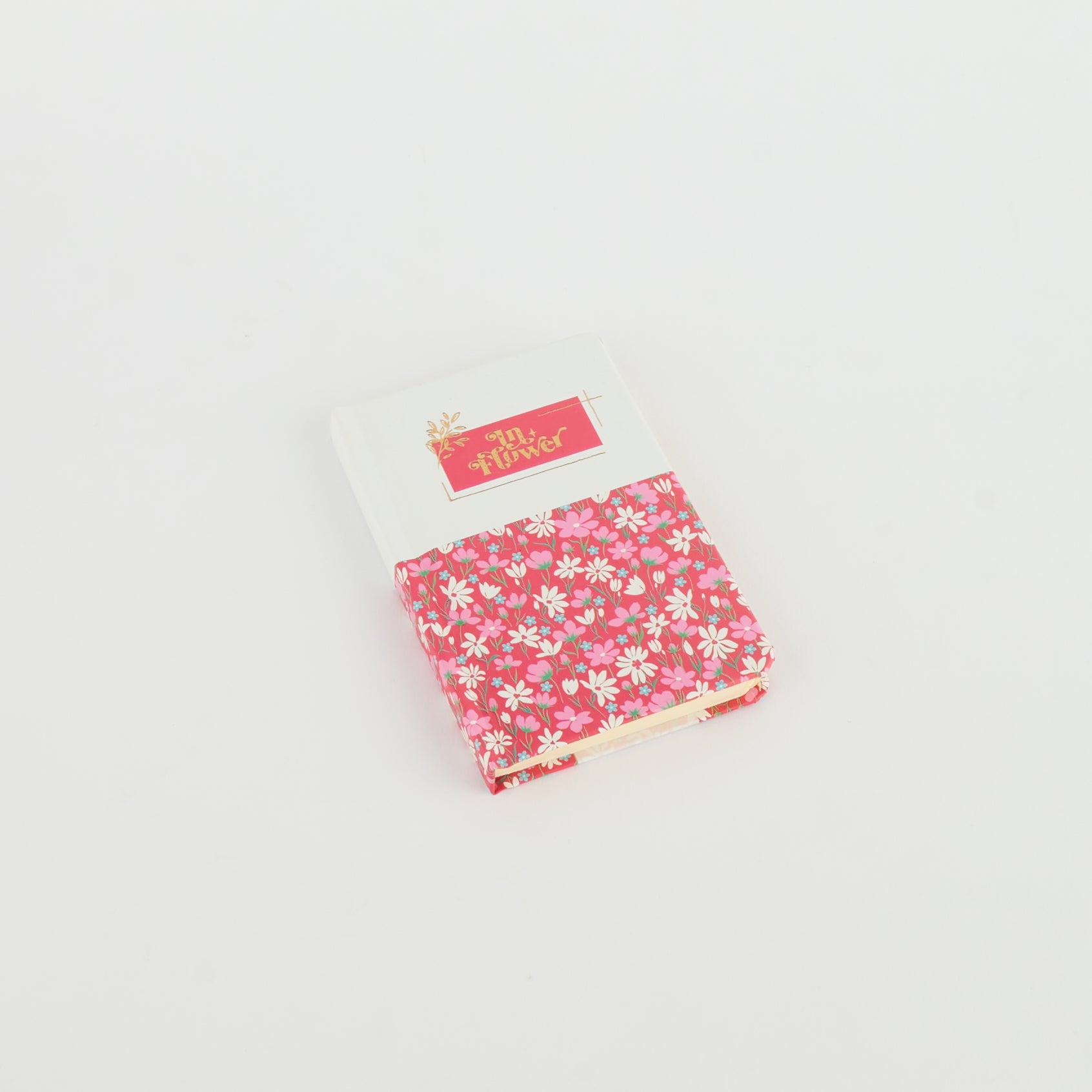 A6 floral notebook by 2BE featuring a colorful flower pattern on a textured cover.