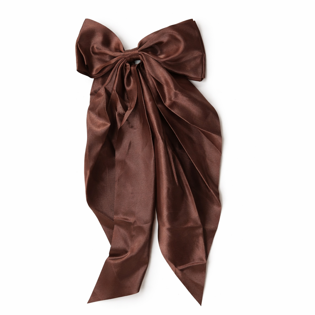 Givana bow hair clip in pastel pink, featuring a classic bow design and attached hairpin.