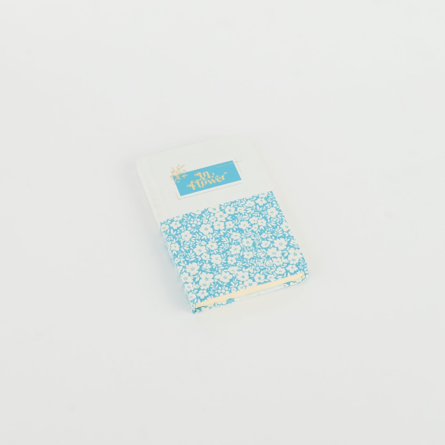 A6 floral notebook by 2BE featuring a vibrant floral design on the cover, perfect for notes and sketches.