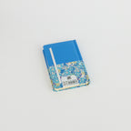 Floral A6 notebook by 2BE featuring a vibrant flower design on a softcover. Ideal for notes and journaling.
