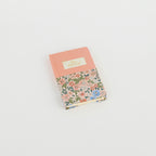 A6 floral notebook by 2BE featuring a colorful flower design on the cover and a classic notebook shape.