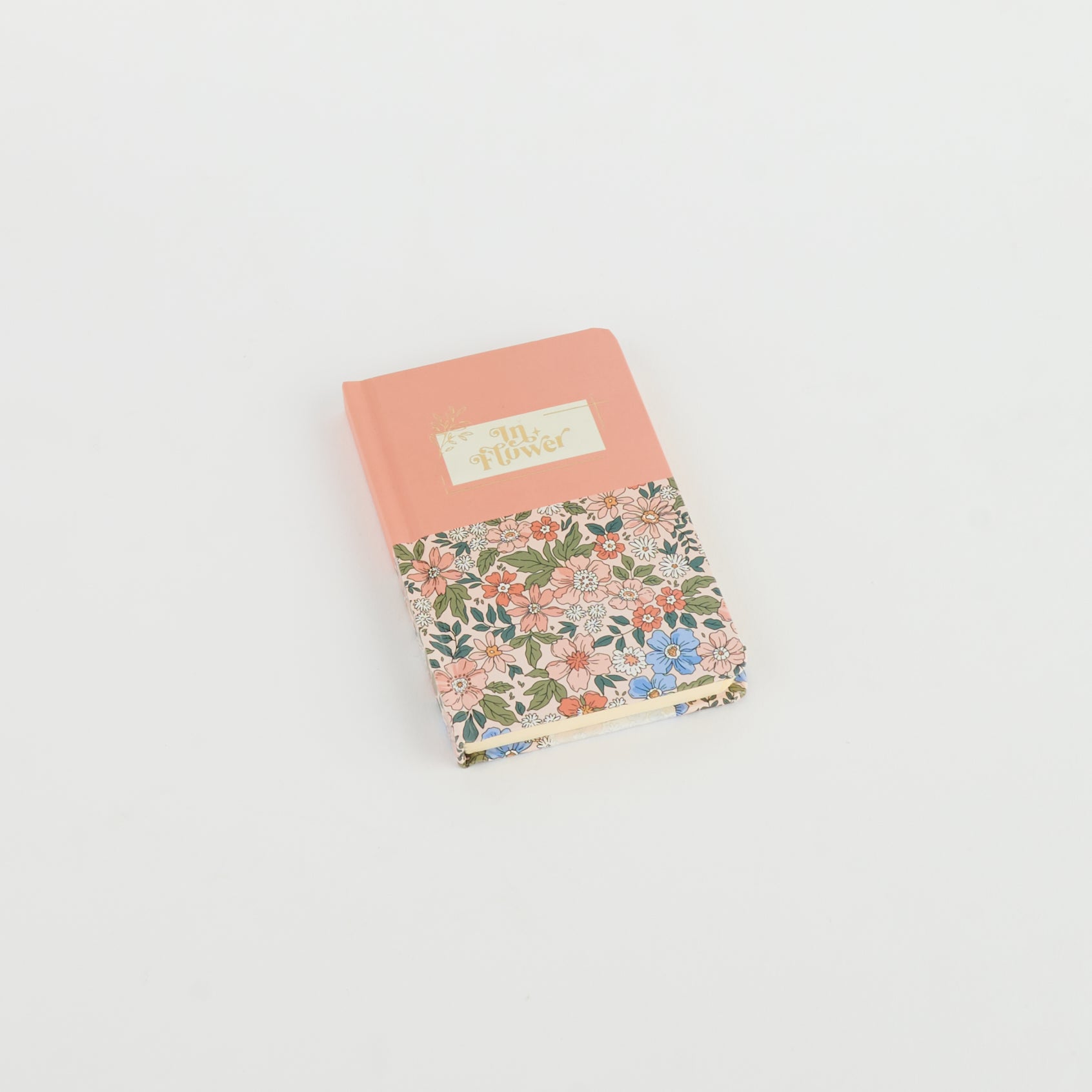 A6 floral notebook by 2BE featuring a colorful flower design on the cover and a classic notebook shape.
