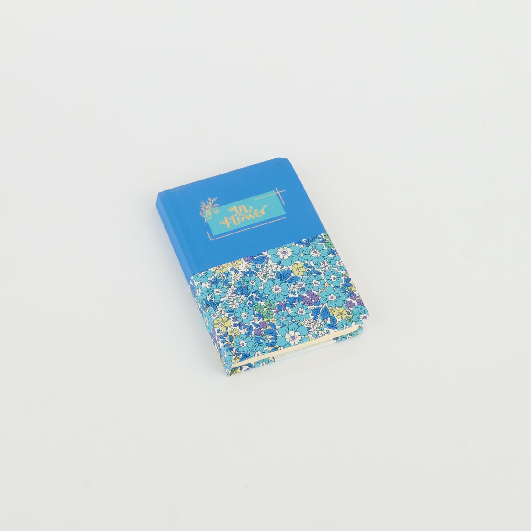 A6 floral notebook by 2BE featuring a vibrant flower design on a textured cover.