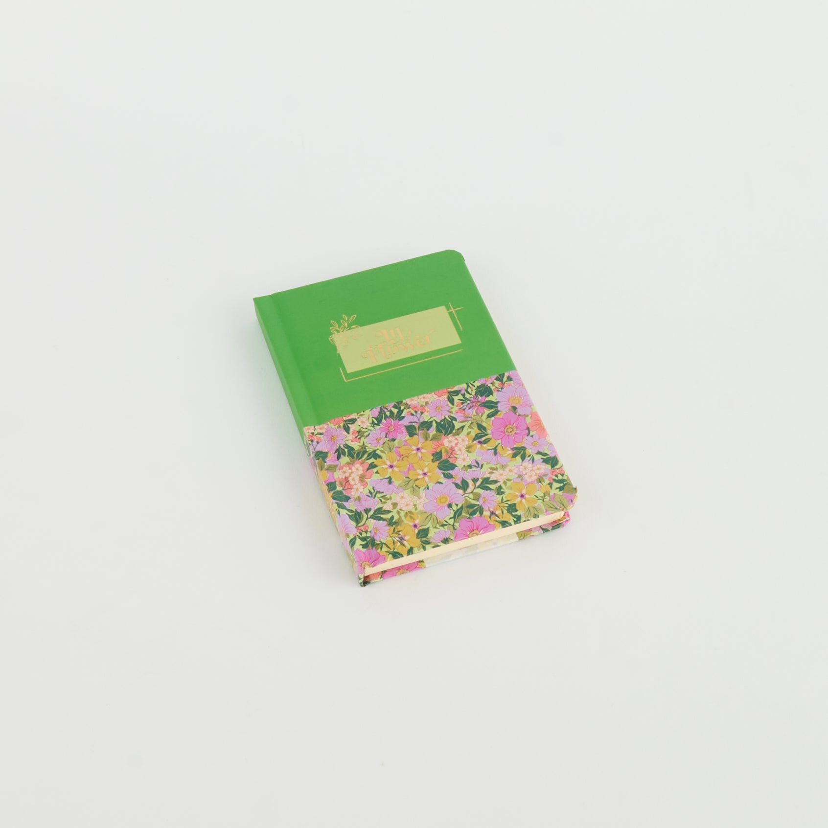 A6 floral notebook by 2BE featuring colorful flower patterns on a textured cover.