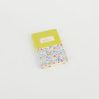 A6 floral notebook by 2BE featuring a colorful flower design on the cover with a sturdy binding.