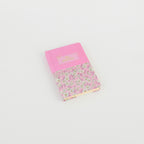 A6 floral notebook by 2BE featuring a vibrant flower pattern on the cover with a sleek, compact design.